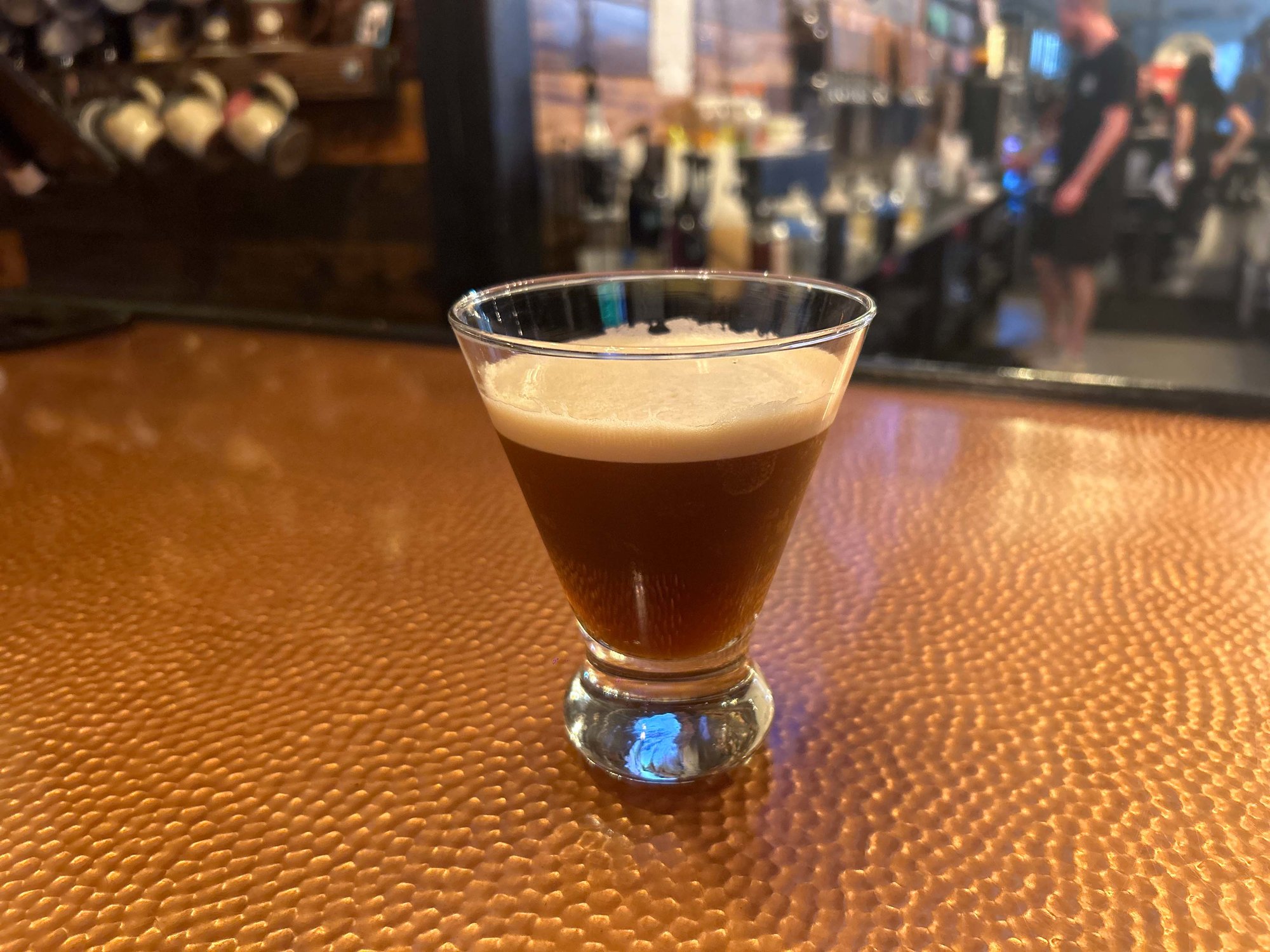 espresso martini in a glass on the bar counter